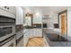 Spacious kitchen with granite countertops, wood floors, and stainless steel appliances at 6650 Village Rd, Parker, CO 80134