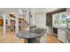 Bright kitchen features an island cooktop, granite countertops, and custom cabinets with hardwood floors at 6650 Village Rd, Parker, CO 80134