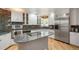 Updated kitchen with stainless steel appliances, granite counters and custom cabinets at 6650 Village Rd, Parker, CO 80134
