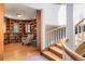Inviting library with hardwood floors, built-in bookshelves, and a cozy reading nook by a spiral staircase at 6650 Village Rd, Parker, CO 80134