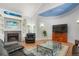 Cozy living room boasts a fireplace, built-in shelves, and a TV with a decorative painted ceiling at 6650 Village Rd, Parker, CO 80134