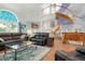Living room featuring a spiral staircase, hardwood floors, and elegant decor at 6650 Village Rd, Parker, CO 80134