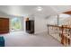 Bright and airy living area with a large window, wardrobe, and staircase at 6650 Village Rd, Parker, CO 80134
