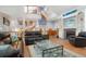 Spacious living room with a spiral staircase, fireplace, and large windows for natural light at 6650 Village Rd, Parker, CO 80134