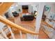Spacious living room with a fireplace and staircase from an elevated view inside the house at 6650 Village Rd, Parker, CO 80134