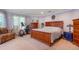 Large bedroom featuring wood furnishings, exercise equipment, and large windows at 6650 Village Rd, Parker, CO 80134
