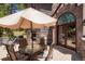 Stone patio features an outdoor dining area, stone walls, and a view of the surrounding landscape at 6650 Village Rd, Parker, CO 80134