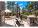 Stone patio with outdoor seating, umbrella, and swing with views of the surrounding landscape at 6650 Village Rd, Parker, CO 80134
