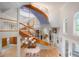 Grand staircase with a unique painted ceiling and elegant chandelier at 6650 Village Rd, Parker, CO 80134