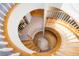 Stunning view of a spiral staircase with wooden steps, white railings, and ample natural light at 6650 Village Rd, Parker, CO 80134
