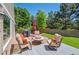 Backyard deck with outdoor furniture, grill, and lush green lawn at 10096 Hughes Pl, Highlands Ranch, CO 80126