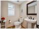 Powder bathroom with dark fixtures, pedestal sink, and neutral walls at 10096 Hughes Pl, Highlands Ranch, CO 80126