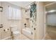 Bathroom featuring tiled shower-tub, floral curtain, and neutral tones at 10096 Hughes Pl, Highlands Ranch, CO 80126