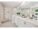 Modern bathroom with double sinks, a shower, and a walk-in closet, exuding style and functionality at 10096 Hughes Pl, Highlands Ranch, CO 80126