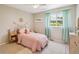 Bright bedroom with pink bedding, white furniture and large windows at 10096 Hughes Pl, Highlands Ranch, CO 80126