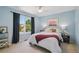 A comfortable bedroom featuring a large window, ceiling fan, and decor at 10096 Hughes Pl, Highlands Ranch, CO 80126