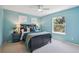 This bedroom features blue walls, a ceiling fan, a window and gray furnishings at 10096 Hughes Pl, Highlands Ranch, CO 80126