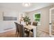 Elegant dining room with hardwood floors and a view of the front yard at 10096 Hughes Pl, Highlands Ranch, CO 80126