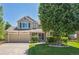 Charming two-story home with a three-car garage and well-maintained front yard at 10096 Hughes Pl, Highlands Ranch, CO 80126