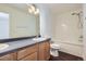 Bathroom featuring tiled shower/tub combo, wood cabinets, double vanity, and modern fixtures at 20000 E Mitchell Pl # 35, Denver, CO 80249