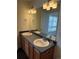 Bathroom featuring double sinks, vanity with storage, large mirror, and elegant lighting fixtures at 20000 E Mitchell Pl # 35, Denver, CO 80249