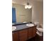 Bathroom featuring dual sinks, wood cabinets, and a tub shower combo at 20000 E Mitchell Pl # 35, Denver, CO 80249