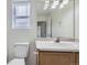 Bathroom with vanity, sink, mirror, and toilet at 20000 E Mitchell Pl # 35, Denver, CO 80249