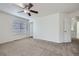 Bedroom featuring neutral carpet, bright light, and a view of the en suite at 20000 E Mitchell Pl # 35, Denver, CO 80249