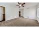 Spacious bedroom featuring neutral carpet, a ceiling fan, and a view of the en suite at 20000 E Mitchell Pl # 35, Denver, CO 80249