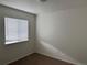 Bedroom with neutral carpet and a large window with blinds at 20000 E Mitchell Pl # 35, Denver, CO 80249
