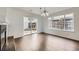 Bright dining room with a modern chandelier, wood floors, and a sliding glass door to the backyard at 20000 E Mitchell Pl # 35, Denver, CO 80249