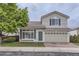 Charming two-story home with a well-manicured lawn, brick driveway, and a front-facing two car garage at 20000 E Mitchell Pl # 35, Denver, CO 80249