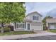 Charming two-story home with a well-manicured lawn, brick driveway, and a front-facing two car garage at 20000 E Mitchell Pl # 35, Denver, CO 80249