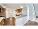 Bright kitchen features stainless steel sink, granite counters, wood cabinets, and wood flooring at 20000 E Mitchell Pl # 35, Denver, CO 80249