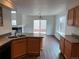 Kitchen features wood cabinets, stainless steel sink and appliances, open layout with adjacent dining room at 20000 E Mitchell Pl # 35, Denver, CO 80249