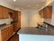 A spacious kitchen with wood cabinets, gray countertops, and stainless steel sink with natural lighting at 20000 E Mitchell Pl # 35, Denver, CO 80249