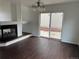Cozy living room featuring dark hardwood floors, a fireplace, and sliding glass doors leading to patio at 20000 E Mitchell Pl # 35, Denver, CO 80249