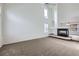 Bright living room featuring high ceilings, a modern fireplace, and neutral carpeting at 20000 E Mitchell Pl # 35, Denver, CO 80249