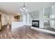 Bright open-concept living room flowing into a kitchen, with wood floors and a modern fireplace at 20000 E Mitchell Pl # 35, Denver, CO 80249