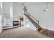 Spacious living room with a modern fireplace, open staircase, and seamless flow into the kitchen at 20000 E Mitchell Pl # 35, Denver, CO 80249