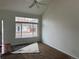 Bright living room featuring a large window that provides natural light, ceiling fan, and hardwood floors at 20000 E Mitchell Pl # 35, Denver, CO 80249