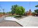 Charming backyard with a well-maintained lawn, mature tree, and privacy fence at 209 S 13Th Ave, Brighton, CO 80601