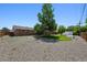 Expansive backyard featuring mature trees, a shed, and a large gravel area at 209 S 13Th Ave, Brighton, CO 80601
