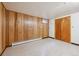 Unfinished basement space features wood paneled walls, a single window, and storage at 209 S 13Th Ave, Brighton, CO 80601