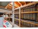 Unfinished basement offering shelving and exposed beams for potential storage at 209 S 13Th Ave, Brighton, CO 80601