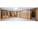 Spacious basement with wood paneling, laminate flooring, and adjacent rooms at 209 S 13Th Ave, Brighton, CO 80601