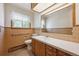 Bright bathroom featuring a large mirror, vanity, and a window to let the sunshine in at 209 S 13Th Ave, Brighton, CO 80601