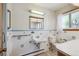 Clean bathroom featuring a sink, toilet, medicine cabinet, and tiled wall at 209 S 13Th Ave, Brighton, CO 80601