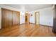 Hardwood floors and large closet doors in the bedroom with three entryways at 209 S 13Th Ave, Brighton, CO 80601