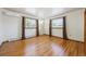 Well-lit bedroom with hardwood floors and natural light coming in from both windows at 209 S 13Th Ave, Brighton, CO 80601